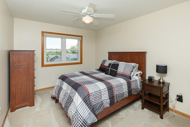 5525 SE 29th Ct, Des Moines, IA 50320 - bedroom featuring light colored carpet, baseboards, and a ceiling fan