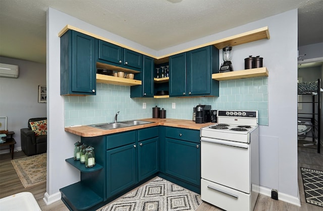 623 W Front St, Stuart, IA 50250 - kitchen featuring open shelves, white electric range, a sink, light wood finished floors, and an AC wall unit