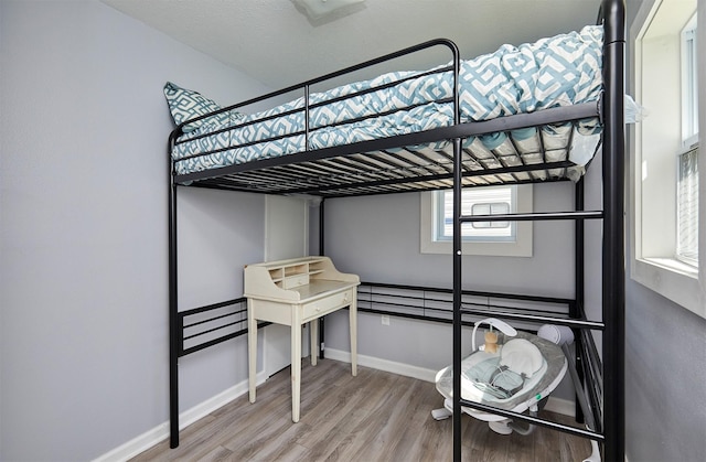 623 W Front St, Stuart, IA 50250 - unfurnished bedroom featuring light wood-type flooring and baseboards
