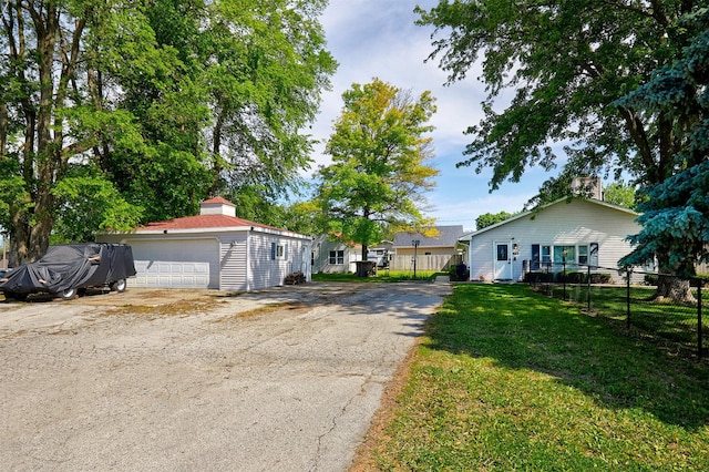 623 W Front St, Stuart, IA 50250 - view of front of property featuring a chimney, a detached garage, and an outbuilding