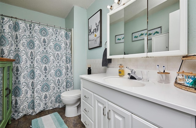623 W Front St, Stuart, IA 50250 - bathroom with vanity, toilet, a shower with shower curtain, and tasteful backsplash