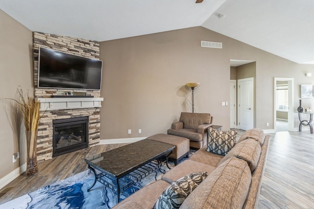 5645 Prairie Grass Dr, Johnston, IA 50131 - living area with wood finished floors, vaulted ceiling, a fireplace, baseboards, and a ceiling fan