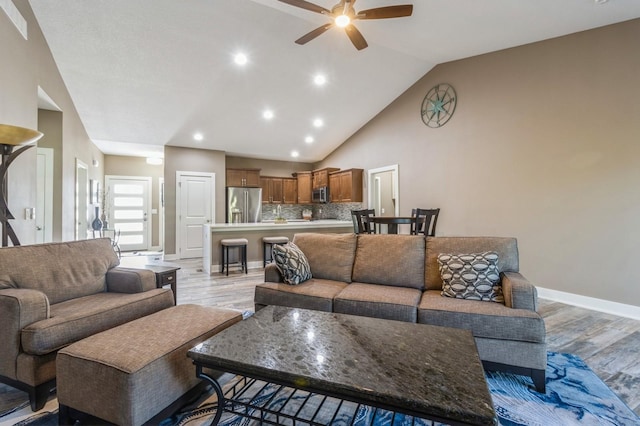 5645 Prairie Grass Dr, Johnston, IA 50131 - living area featuring a ceiling fan, light wood-type flooring, lofted ceiling, baseboards, and recessed lighting