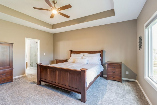 5645 Prairie Grass Dr, Johnston, IA 50131 - bedroom with light carpet, a raised ceiling, baseboards, and ensuite bath