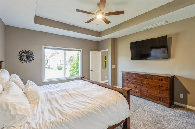 5645 Prairie Grass Dr, Johnston, IA 50131 - bedroom with baseboards, carpet, a raised ceiling, and ceiling fan
