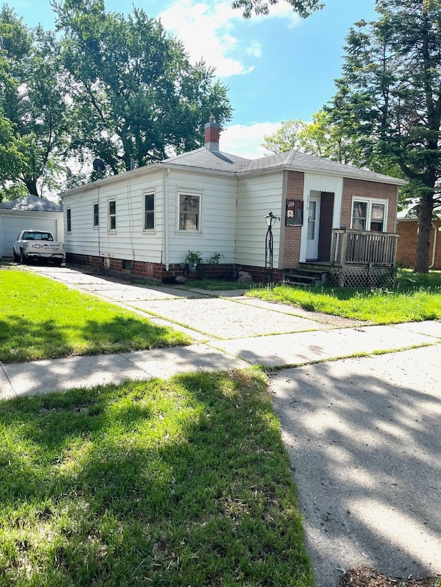 1216 Marshall St, Boone, IA 50036 - view of front of house with a front lawn, brick siding, and a chimney