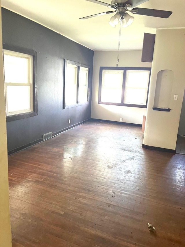 1216 Marshall St, Boone, IA 50036 - empty room with ceiling fan, wood-type flooring, and baseboards
