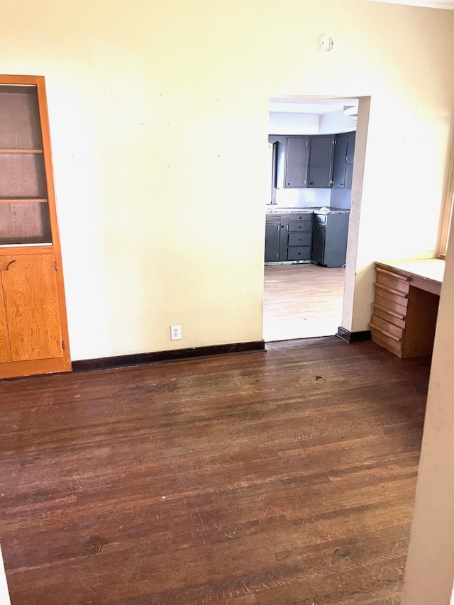 1216 Marshall St, Boone, IA 50036 - unfurnished room featuring dark wood-style floors, baseboards, and a smoke detector