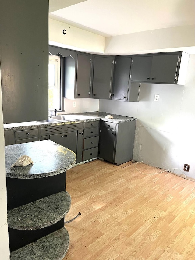 1216 Marshall St, Boone, IA 50036 - kitchen featuring a sink, light wood-style flooring, and gray cabinetry