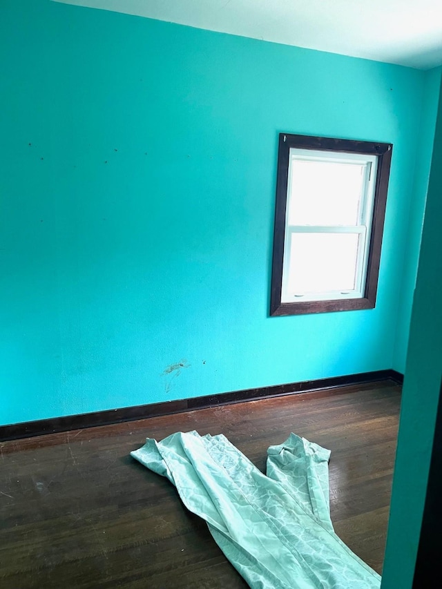 1216 Marshall St, Boone, IA 50036 - empty room featuring baseboards and wood finished floors