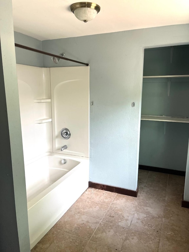 1216 Marshall St, Boone, IA 50036 - bathroom with shower / bathtub combination, baseboards, and a spacious closet