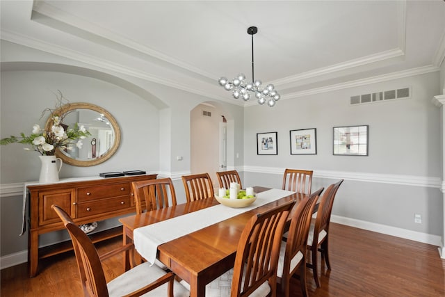 3322 Harrison Rd, Ames, IA 50010 - dining area with arched walkways, a tray ceiling, wood finished floors, ornamental molding, and baseboards