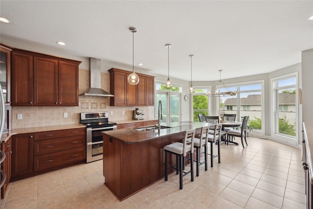 3322 Harrison Rd, Ames, IA 50010 - kitchen with range with two ovens, wall chimney exhaust hood, a sink, backsplash, and a kitchen breakfast bar