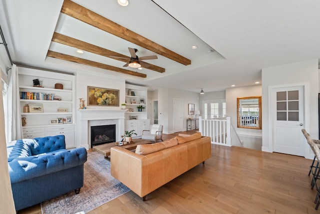 901 Cardinal Dr, Polk City, IA 50226 - living area with light wood-style flooring, a glass covered fireplace, recessed lighting, a ceiling fan, and baseboards