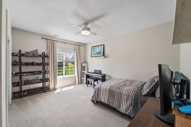 901 Cardinal Dr, Polk City, IA 50226 - carpeted bedroom with a textured ceiling and ceiling fan