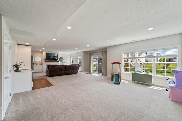 901 Cardinal Dr, Polk City, IA 50226 - living area with light carpet, a textured ceiling, recessed lighting, and baseboards