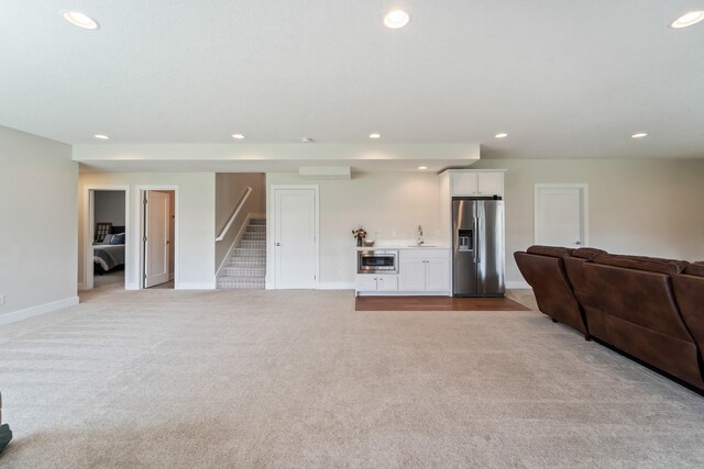 901 Cardinal Dr, Polk City, IA 50226 - carpeted living room featuring bar with sink, recessed lighting, stairway, and baseboards