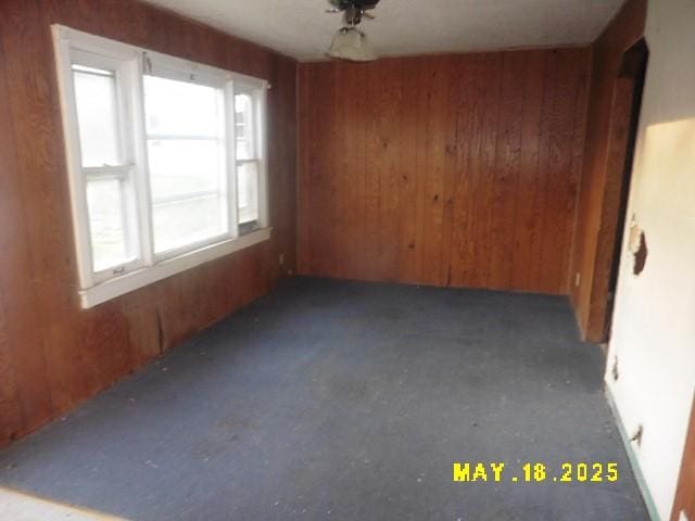 206 S D St, Indianola, IA 50125 - unfurnished dining area featuring wood walls