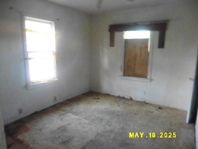 206 S D St, Indianola, IA 50125 - spare room with healthy amount of natural light, carpet floors, and a ceiling fan