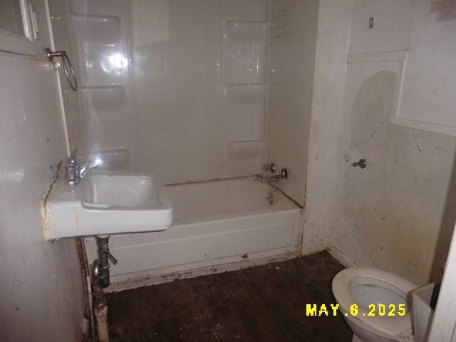 410 W 2nd Ave, Indianola, IA 50125 - bathroom with toilet, a sink, and tub / shower combination