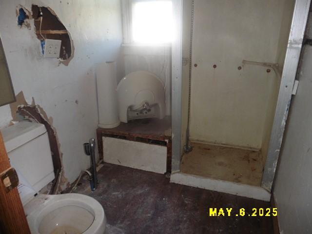 410 W 2nd Ave, Indianola, IA 50125 - bathroom featuring toilet and a stall shower
