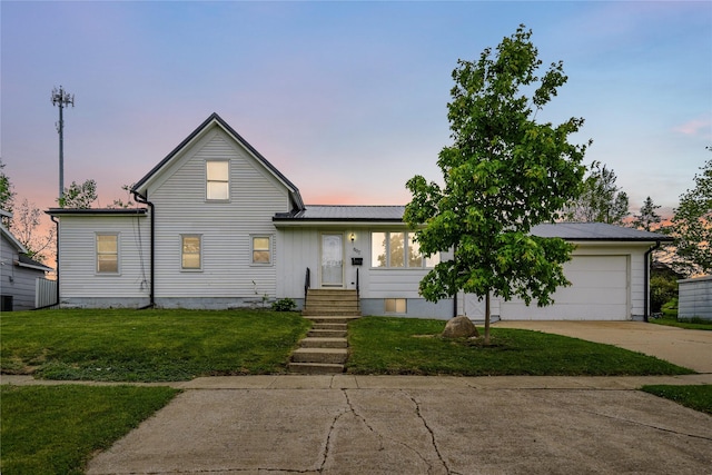 807 Center St, Grinnell, IA 50112 - view of front facade featuring driveway, a front yard, metal roof, and a garage