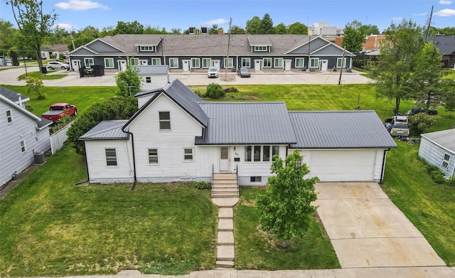 807 Center St, Grinnell, IA 50112 - rear view of house with a residential view, metal roof, a garage, and cooling unit