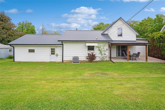 807 Center St, Grinnell, IA 50112 - back of property featuring central air condition unit, a patio, a yard, and metal roof