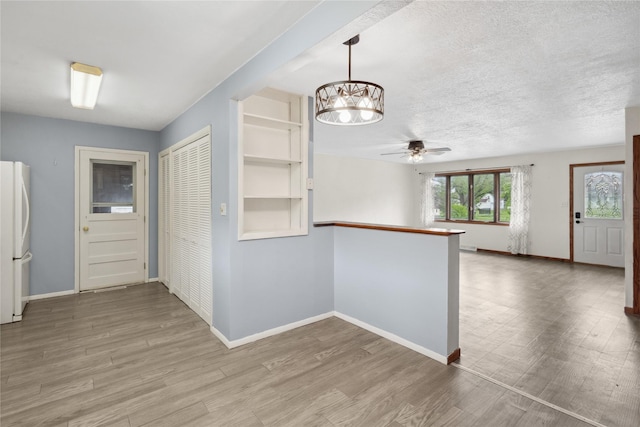 807 Center St, Grinnell, IA 50112 - corridor with a chandelier and wood finished floors