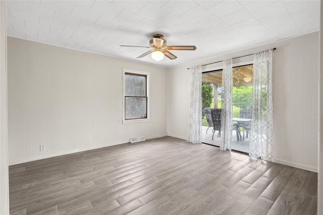 807 Center St, Grinnell, IA 50112 - unfurnished room featuring a ceiling fan, wood finished floors, and baseboards
