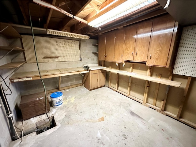 807 Center St, Grinnell, IA 50112 - unfinished below grade area featuring a workshop area and concrete block wall