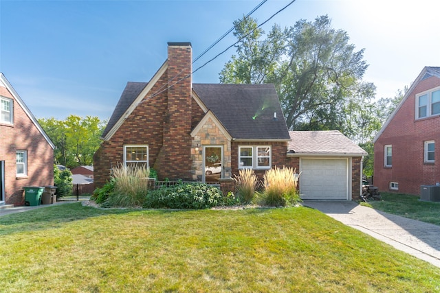 6704 Elmcrest Dr, Windsor Heights, IA 50324 - tudor-style house with a chimney, a garage, central air condition unit, and a front yard