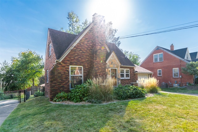 6704 Elmcrest Dr, Windsor Heights, IA 50324 - view of home's exterior featuring cooling unit, a gate, brick siding, a chimney, and an attached garage