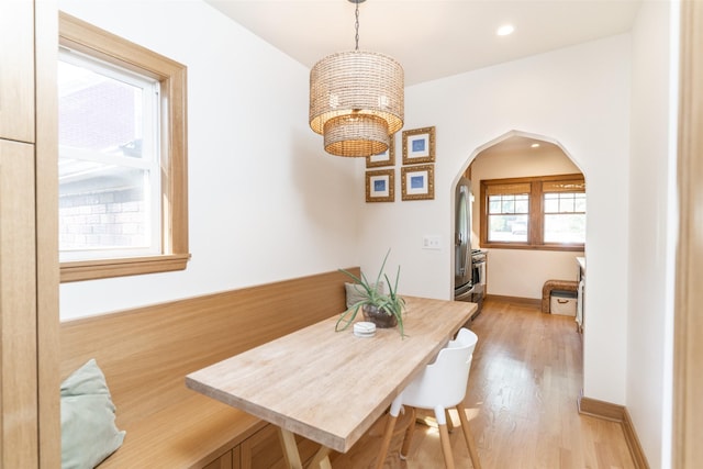 6704 Elmcrest Dr, Windsor Heights, IA 50324 - dining area with arched walkways, light wood-type flooring, recessed lighting, and baseboards