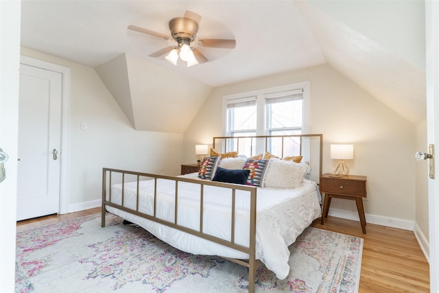6704 Elmcrest Dr, Windsor Heights, IA 50324 - bedroom with wood finished floors, vaulted ceiling, a ceiling fan, and baseboards
