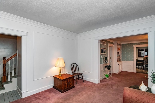 113 N Locust St, Madrid, IA 50156 - sitting room with ornamental molding, carpet floors, stairway, a decorative wall, and wainscoting