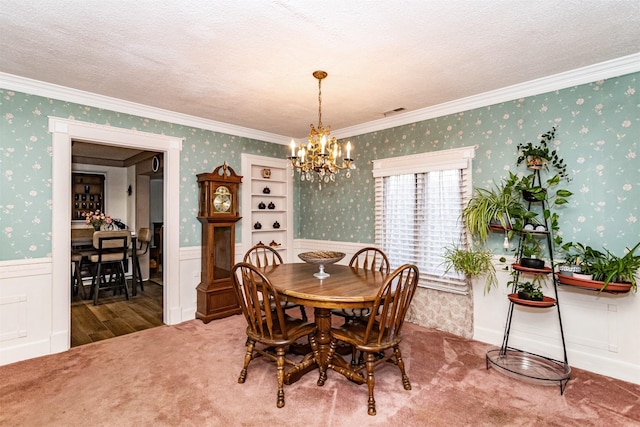 113 N Locust St, Madrid, IA 50156 - carpeted dining room with wallpapered walls, wainscoting, a chandelier, and crown molding
