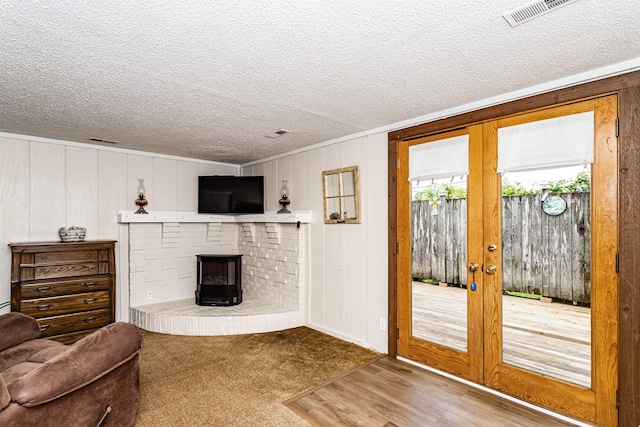 113 N Locust St, Madrid, IA 50156 - living room featuring french doors, a textured ceiling, and wood finished floors