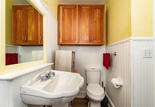 113 N Locust St, Madrid, IA 50156 - bathroom with a sink, a wainscoted wall, and toilet