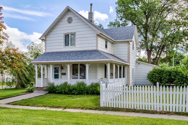 113 N Locust St, Madrid, IA 50156 - view of front facade featuring a porch, a shingled roof, and a chimney
