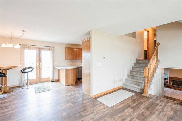 5545 E Douglas Ave, Des Moines, IA 50317 - kitchen with light wood finished floors, stainless steel dishwasher, baseboards, and light countertops