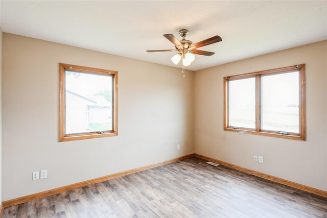 5545 E Douglas Ave, Des Moines, IA 50317 - unfurnished room with baseboards, light wood-type flooring, and ceiling fan