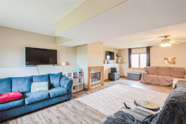 5545 E Douglas Ave, Des Moines, IA 50317 - living room with wood finished floors, a glass covered fireplace, and a ceiling fan