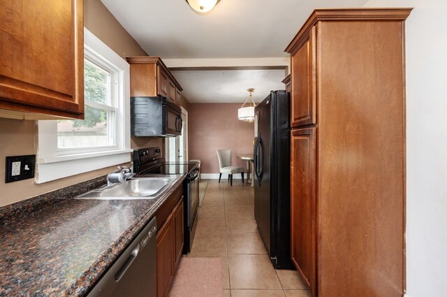 2004 40th St, Des Moines, IA 50310 - kitchen featuring black appliances, a sink, light tile patterned floors, and brown cabinetry