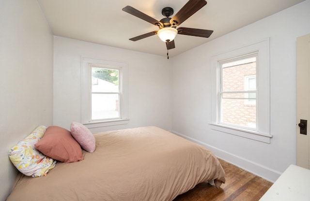 2004 40th St, Des Moines, IA 50310 - bedroom featuring wood finished floors, baseboards, and a ceiling fan