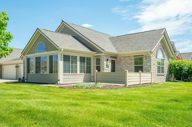 3305 SE Glenstone Dr Unit 236, Grimes, IA 50111 - view of front of property featuring a shingled roof, stone siding, a garage, driveway, and a sunroom