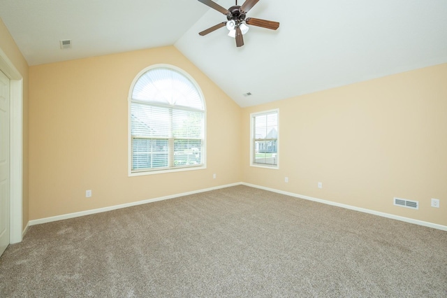 3305 SE Glenstone Dr Unit 236, Grimes, IA 50111 - empty room featuring a ceiling fan, carpet floors, lofted ceiling, and baseboards