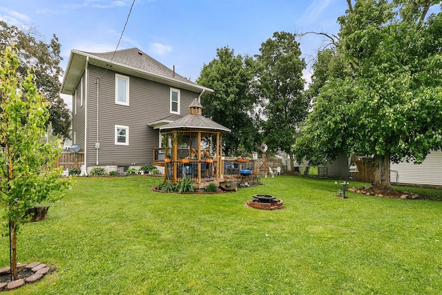 305 E State St, Baxter, IA 50028 - back of house featuring a gazebo, a fire pit, and roof with shingles