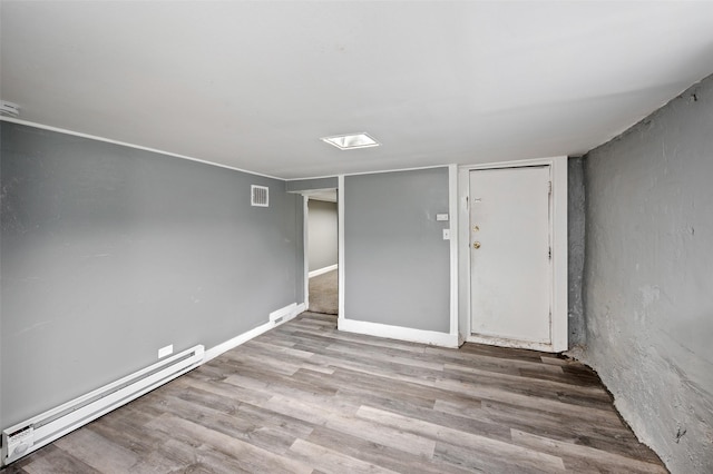 732 19th St, Des Moines, IA 50314 - spare room with a baseboard radiator, wood finished floors, and baseboards