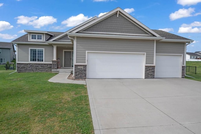 3911 NW 14th Ct, Ankeny, IA 50023 - craftsman house featuring stone siding, an attached garage, concrete driveway, and a front lawn